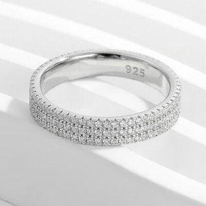 a white gold ring with rows of diamonds