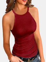 a woman wearing a red tank top and jeans