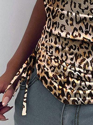 a woman is wearing a leopard print top