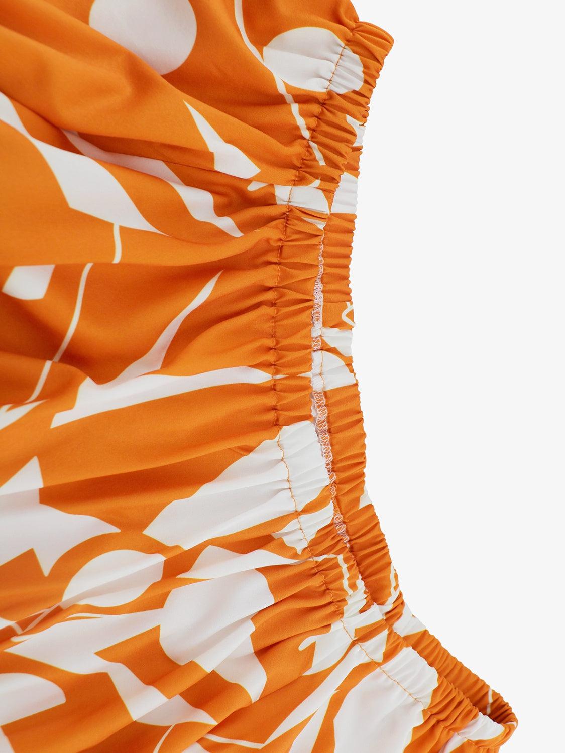 a close up of an orange and white dress