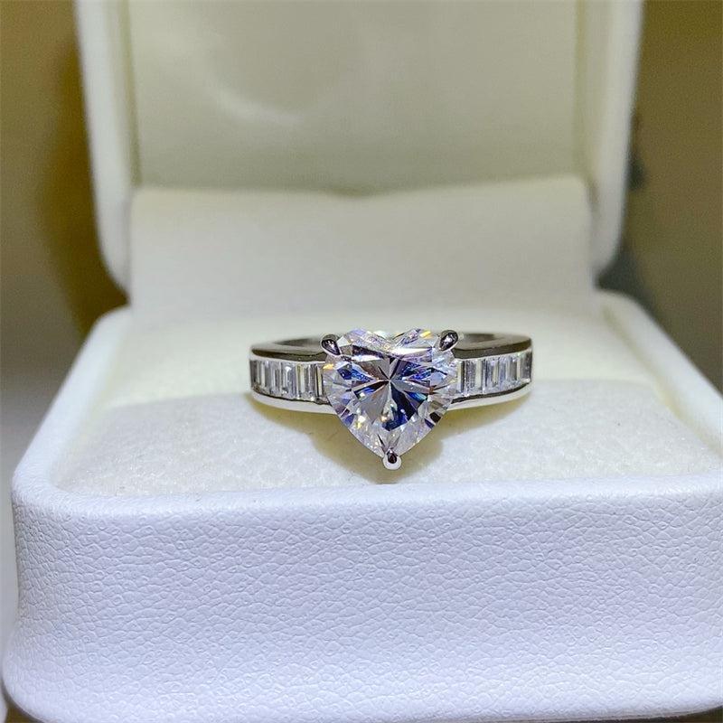 a ring with a heart shaped diamond in a box