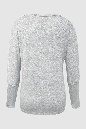 the back of a women's grey sweater