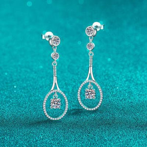 a pair of earrings on a blue background