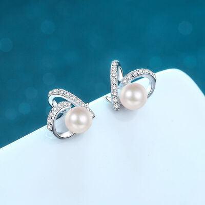a pair of pearl and diamond earrings