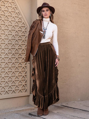 a woman wearing a hat and a brown skirt