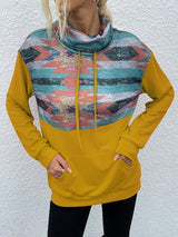 a woman wearing a yellow hoodie and black leggings