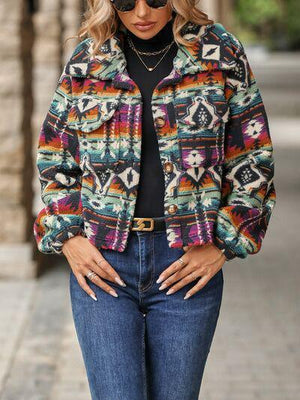 a woman wearing a colorful jacket and jeans