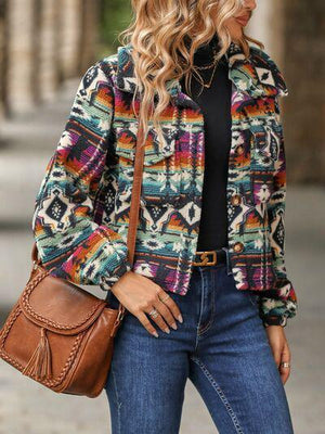 a woman wearing a colorful jacket and jeans