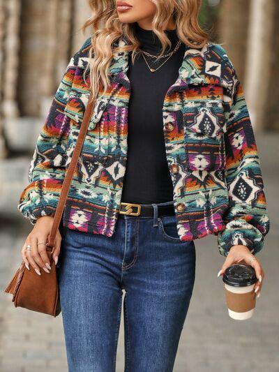 a woman wearing a colorful jacket and jeans