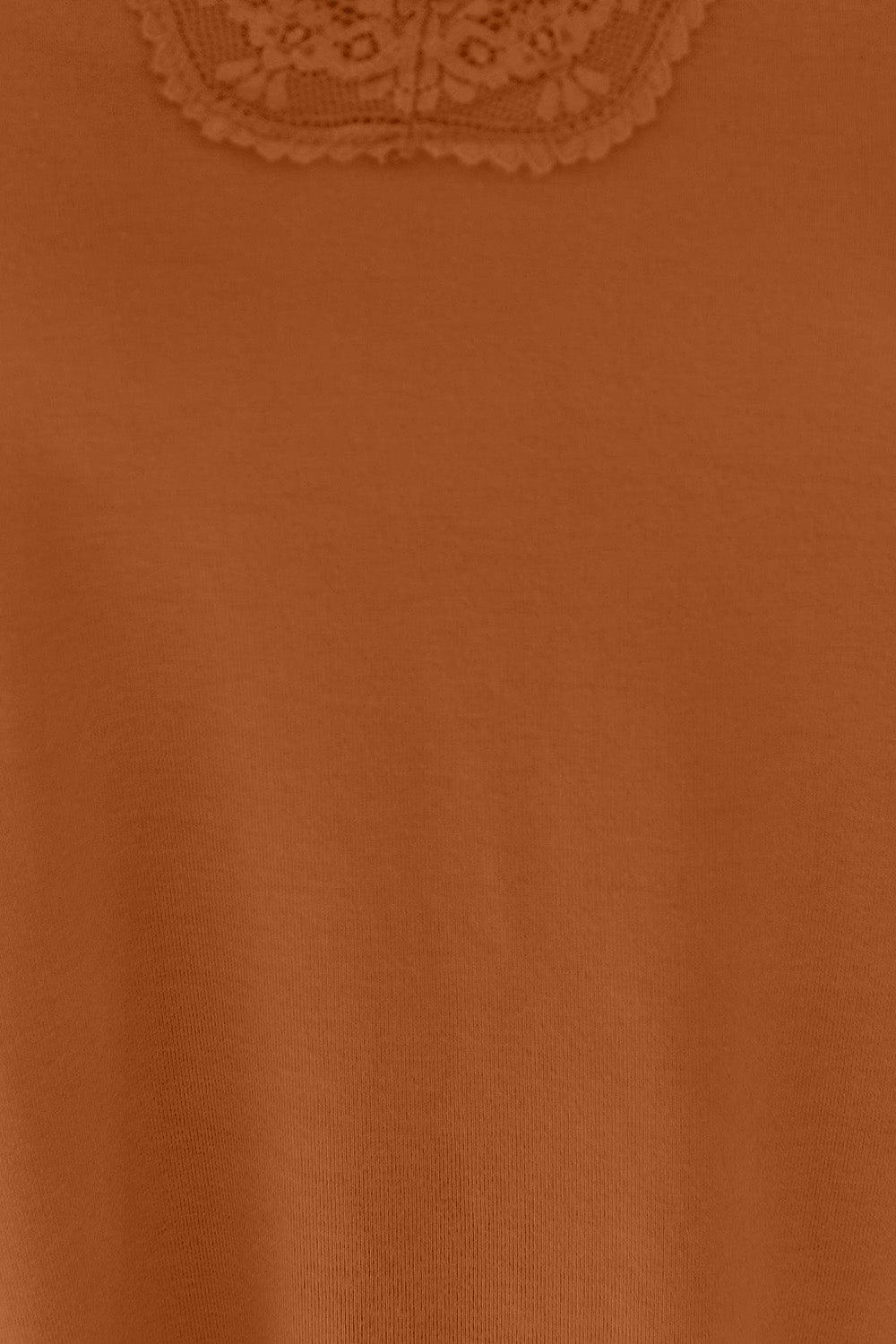 a close up of a person wearing a brown shirt