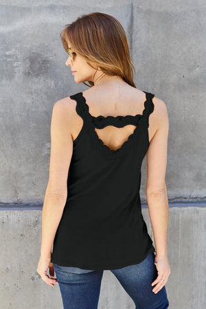 a woman wearing a black top with a cut out back