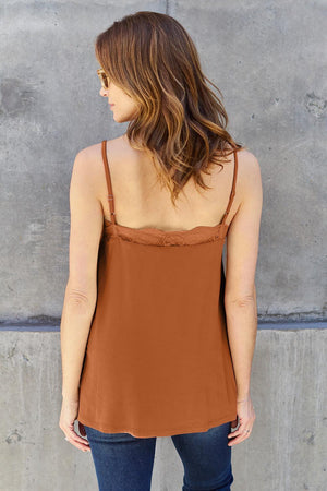 a woman standing in front of a concrete wall