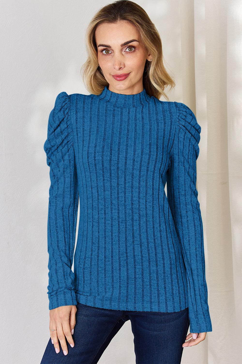 a woman wearing a blue sweater and jeans