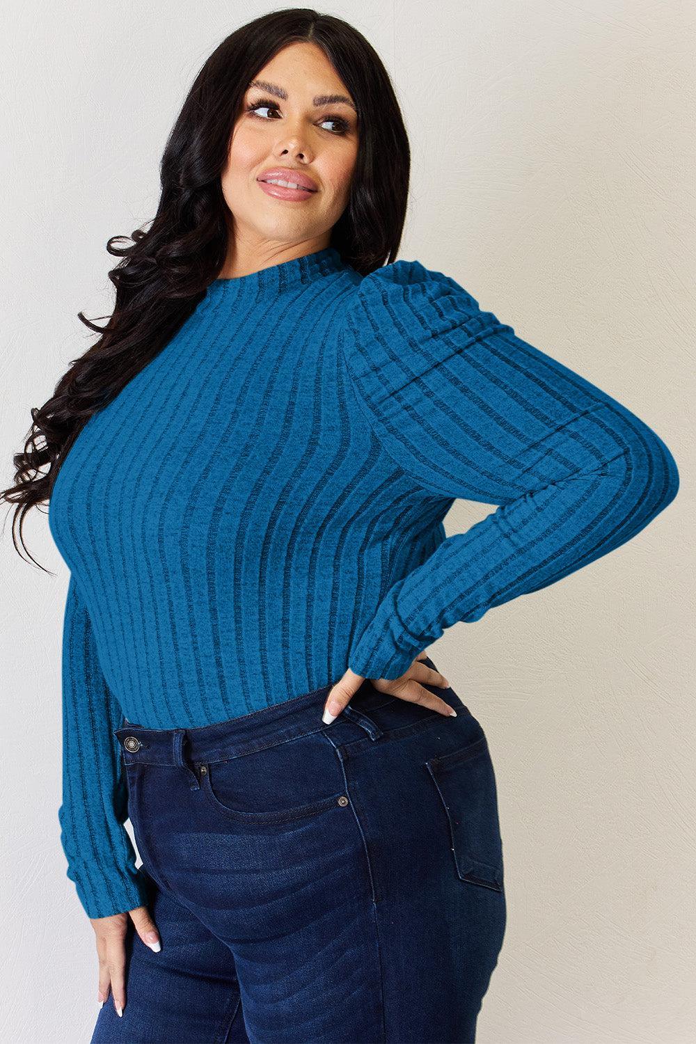 a woman in a blue sweater posing for a picture