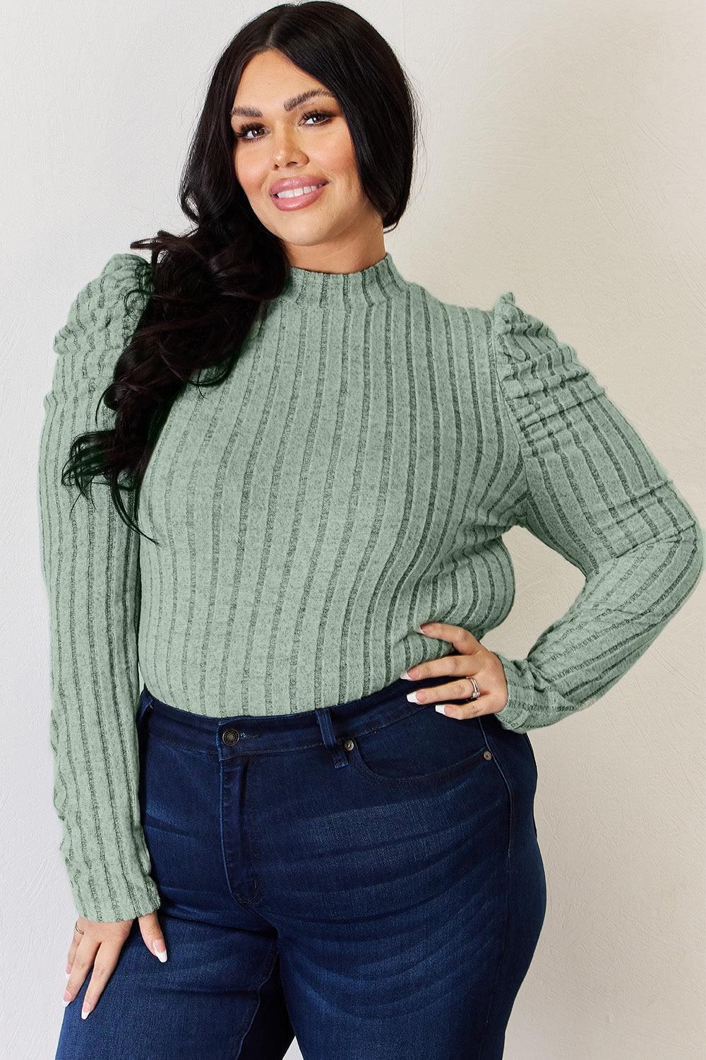 a woman in a green sweater posing for a picture