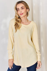 a woman in a yellow sweater posing for a picture