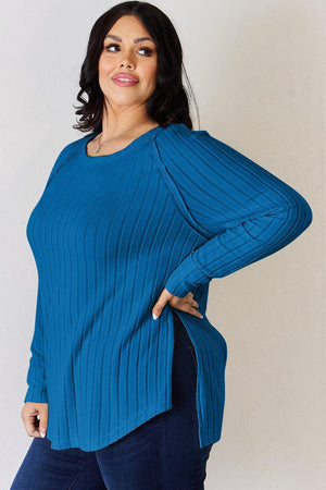 a woman in a blue top poses for a picture
