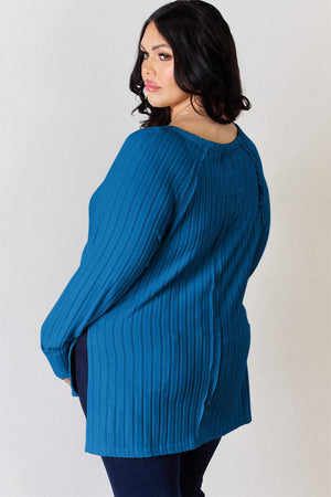 a woman in a blue sweater is posing for a picture