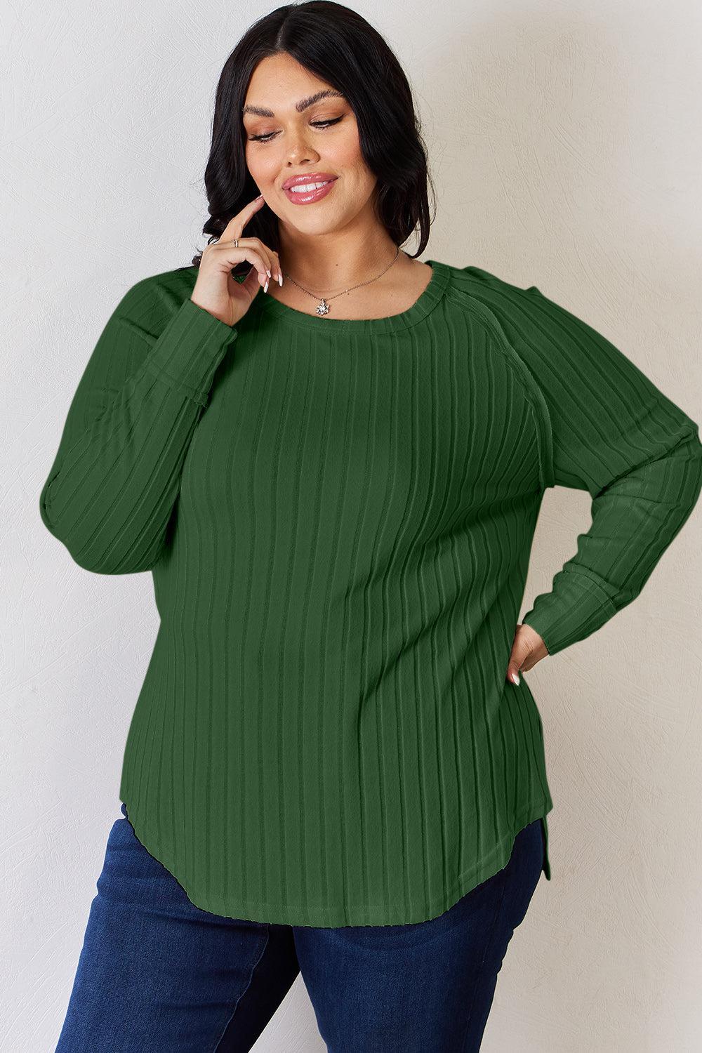 a woman in a green sweater is talking on her cell phone