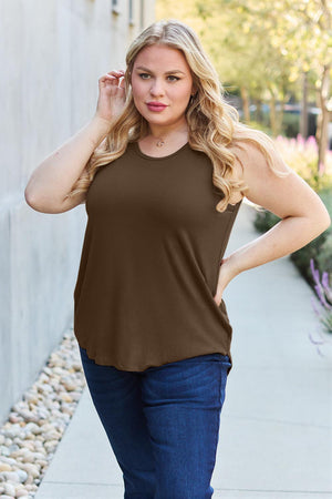 a woman in a brown top posing for a picture