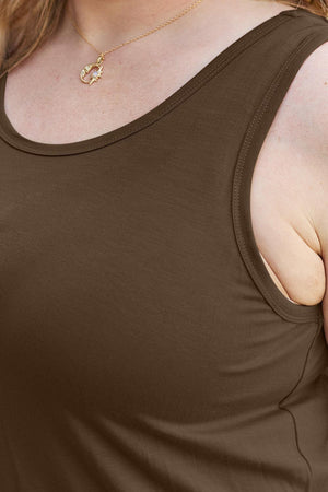 a woman wearing a brown tank top and a gold necklace