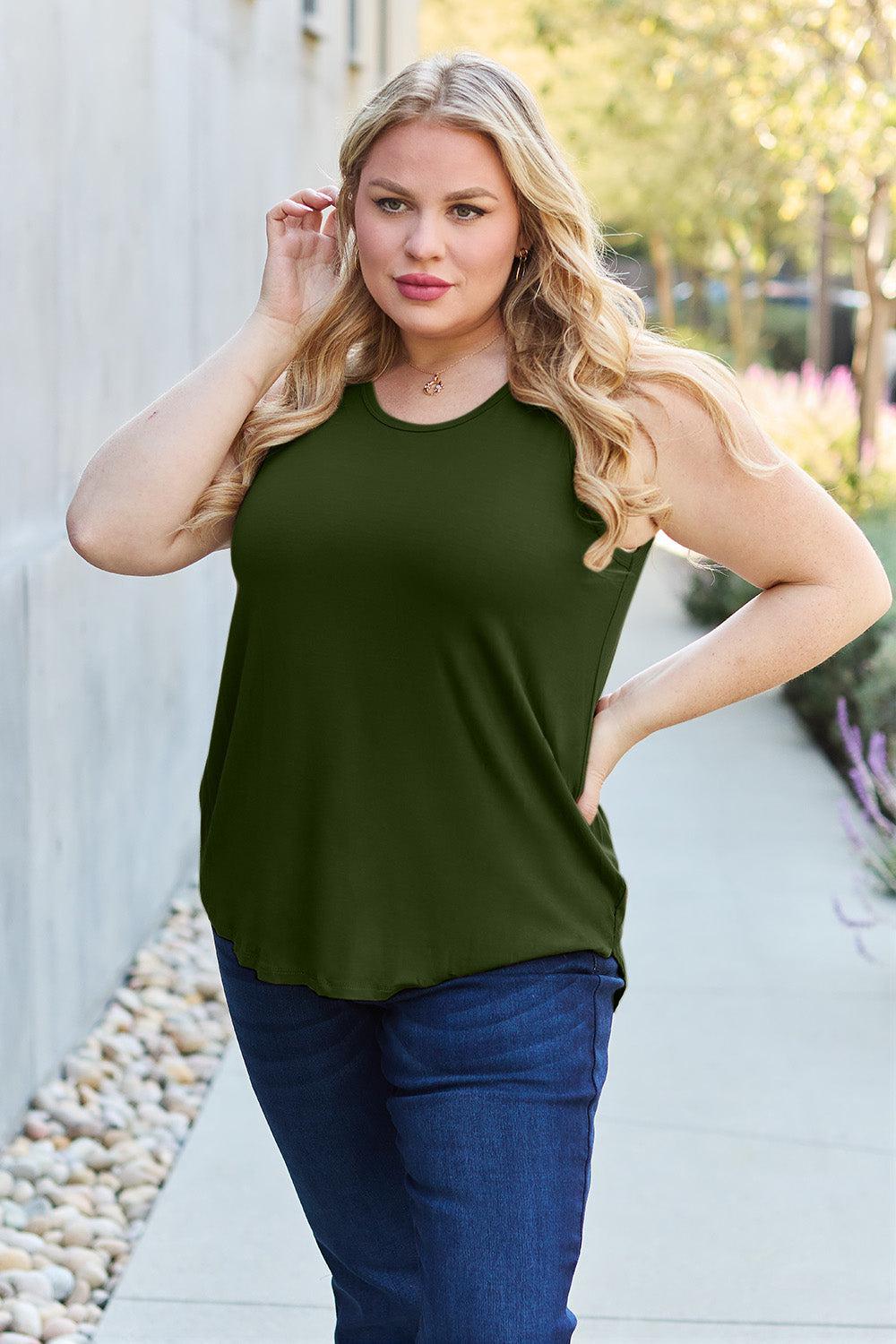 a woman in a green top posing for a picture