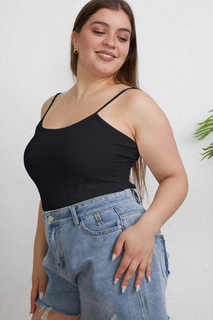 a woman wearing a black top and ripped jeans