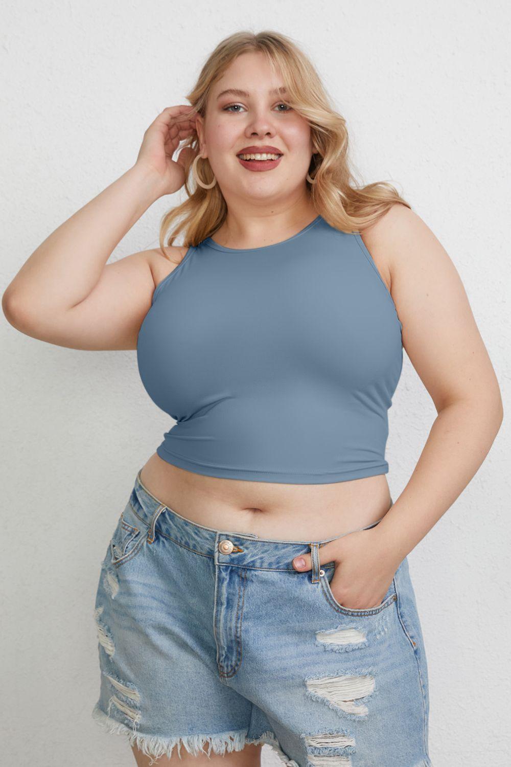 a woman in a blue top posing for a picture