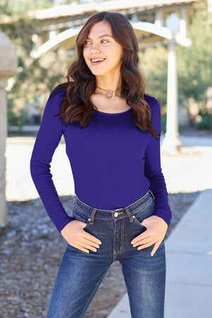 a woman standing on a sidewalk with her hands on her hips