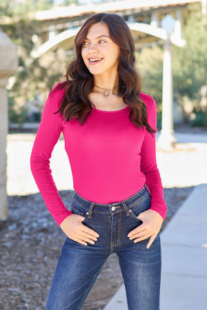 a woman in a pink shirt is posing for a picture