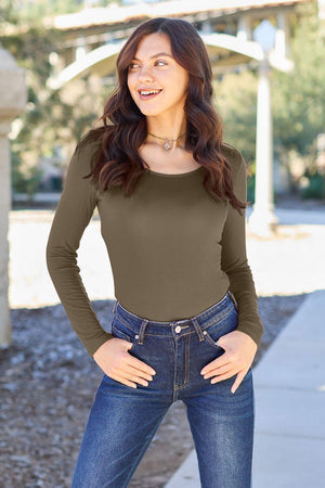 a woman standing on a sidewalk with her hands on her hips