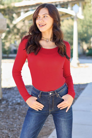 a woman in a red shirt is posing for a picture