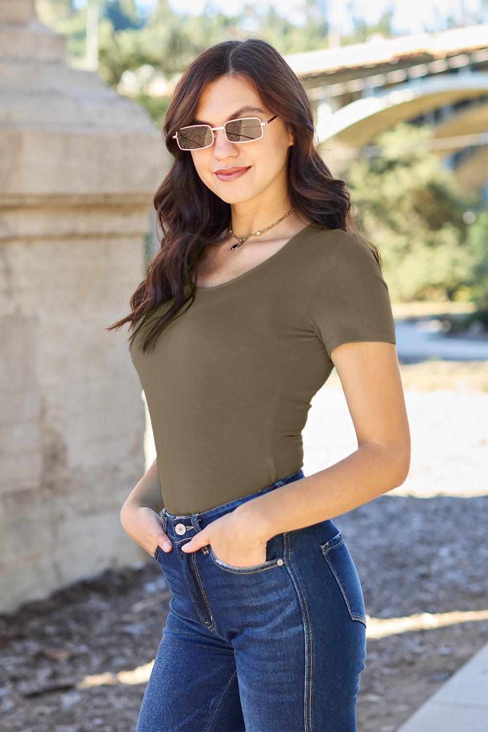 a woman wearing a brown shirt and jeans