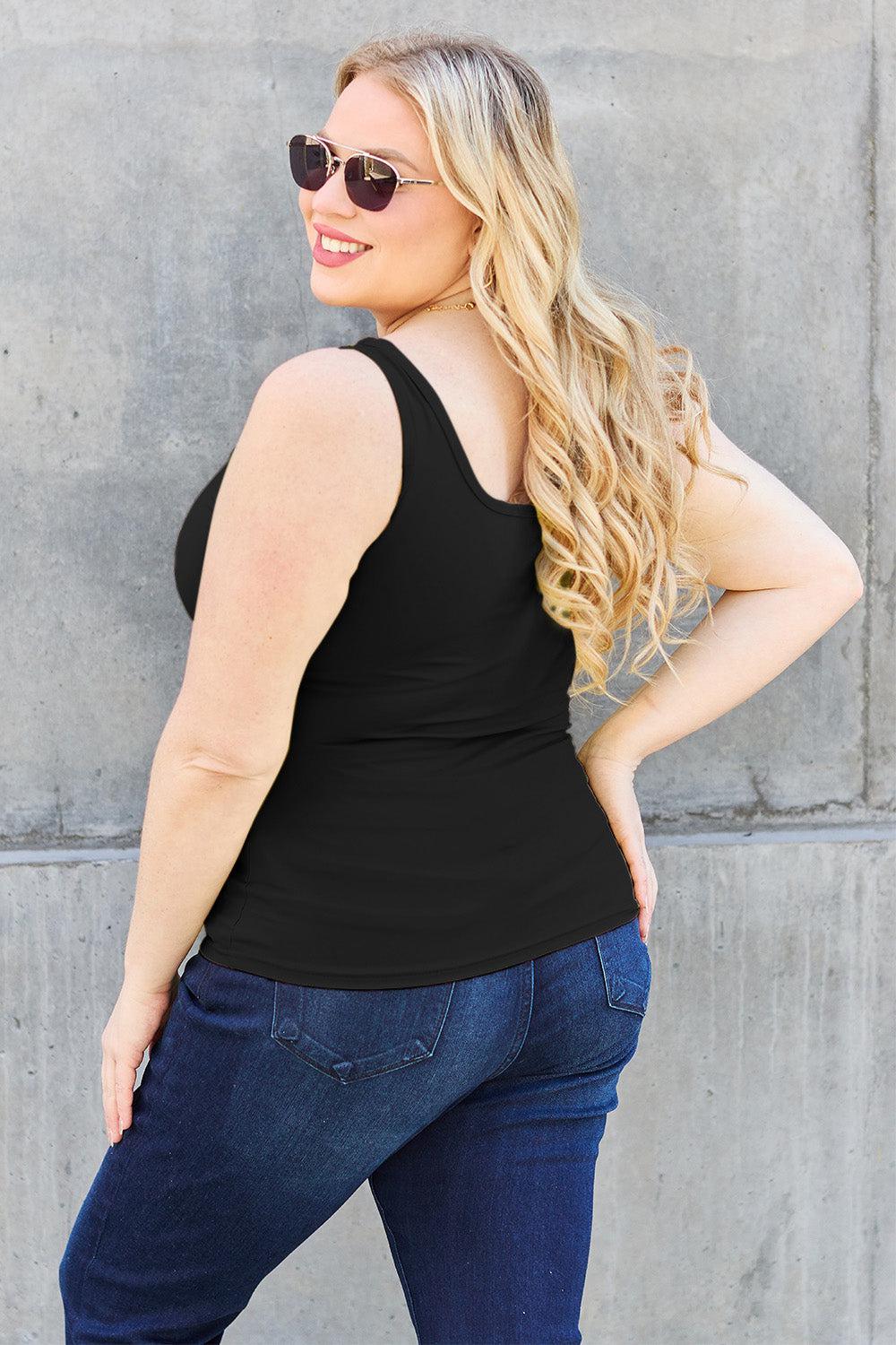 a woman wearing a black top and jeans