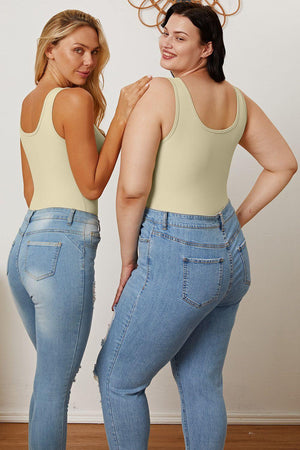 two women in high waisted jeans are facing each other