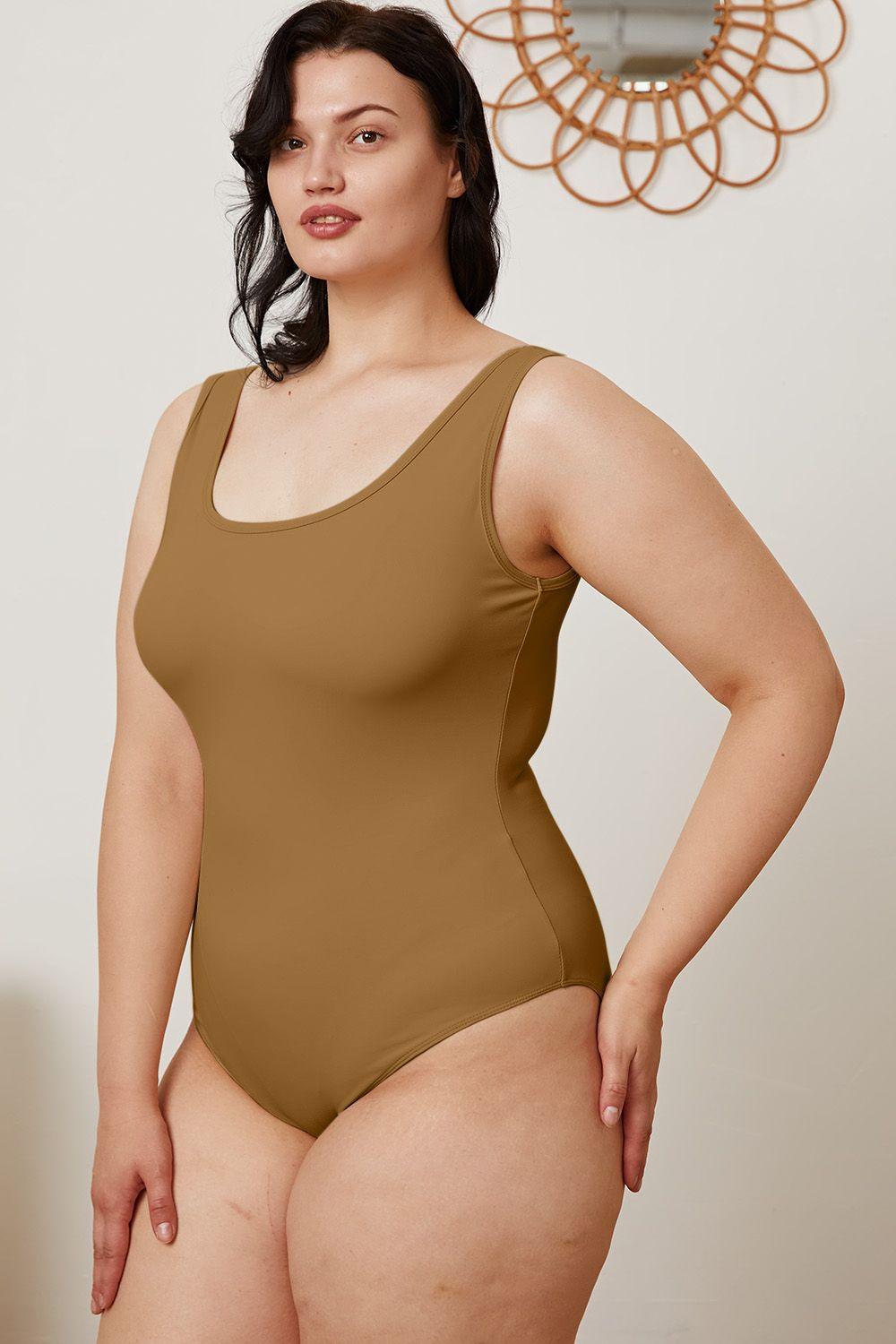 a woman in a bodysuit posing for a picture