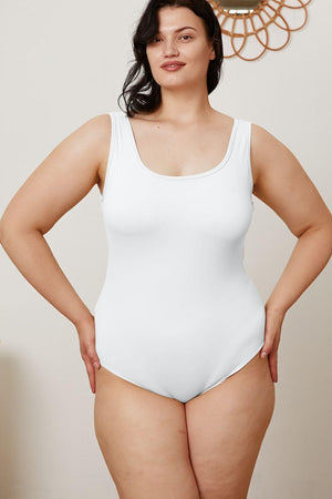 a woman in a white bodysuit posing for a picture