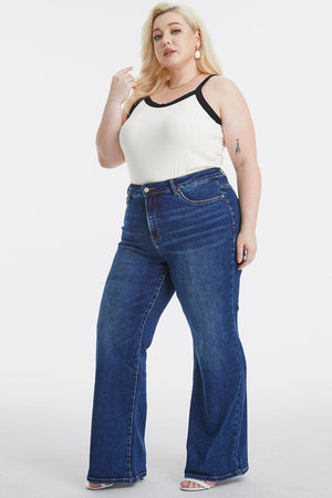 a woman in a white tank top and blue jeans