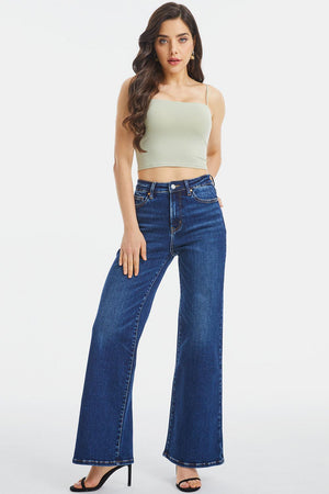 a woman in high rise jeans and a crop top