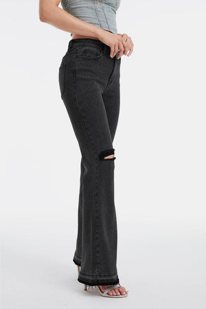 a woman is standing in a pair of black jeans
