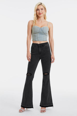 a woman in a crop top and black jeans