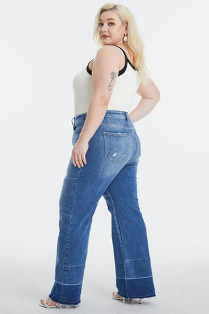 a woman in a white tank top and blue jeans