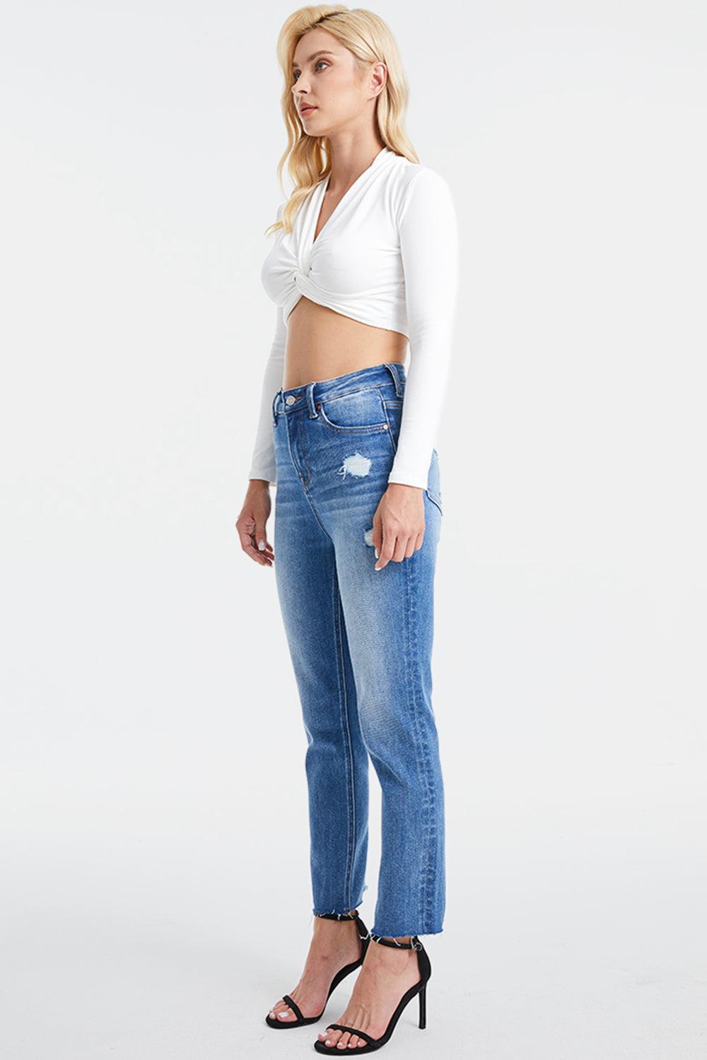 a woman in white shirt and jeans posing for a picture