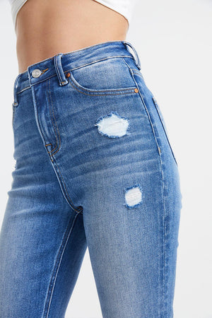 a woman's butt showing her ripped jeans