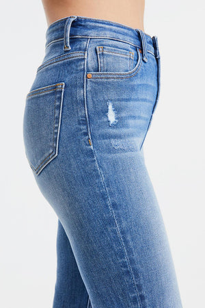 a woman's butt showing her ripped jeans