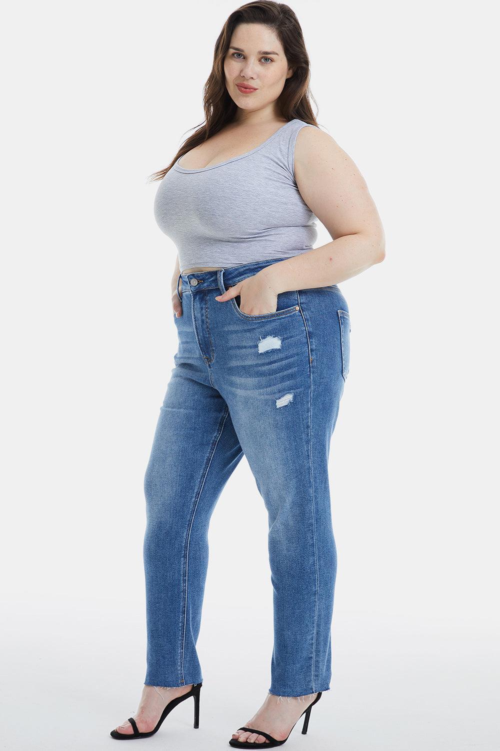 a woman in a grey shirt and jeans