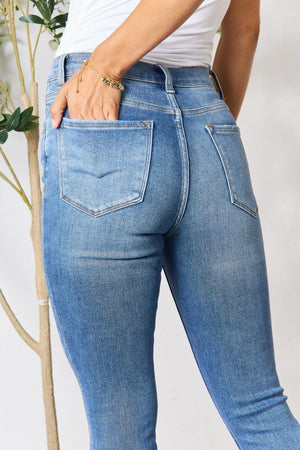 a woman is holding her butt in her jeans