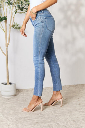 a woman wearing high rise jeans and heels