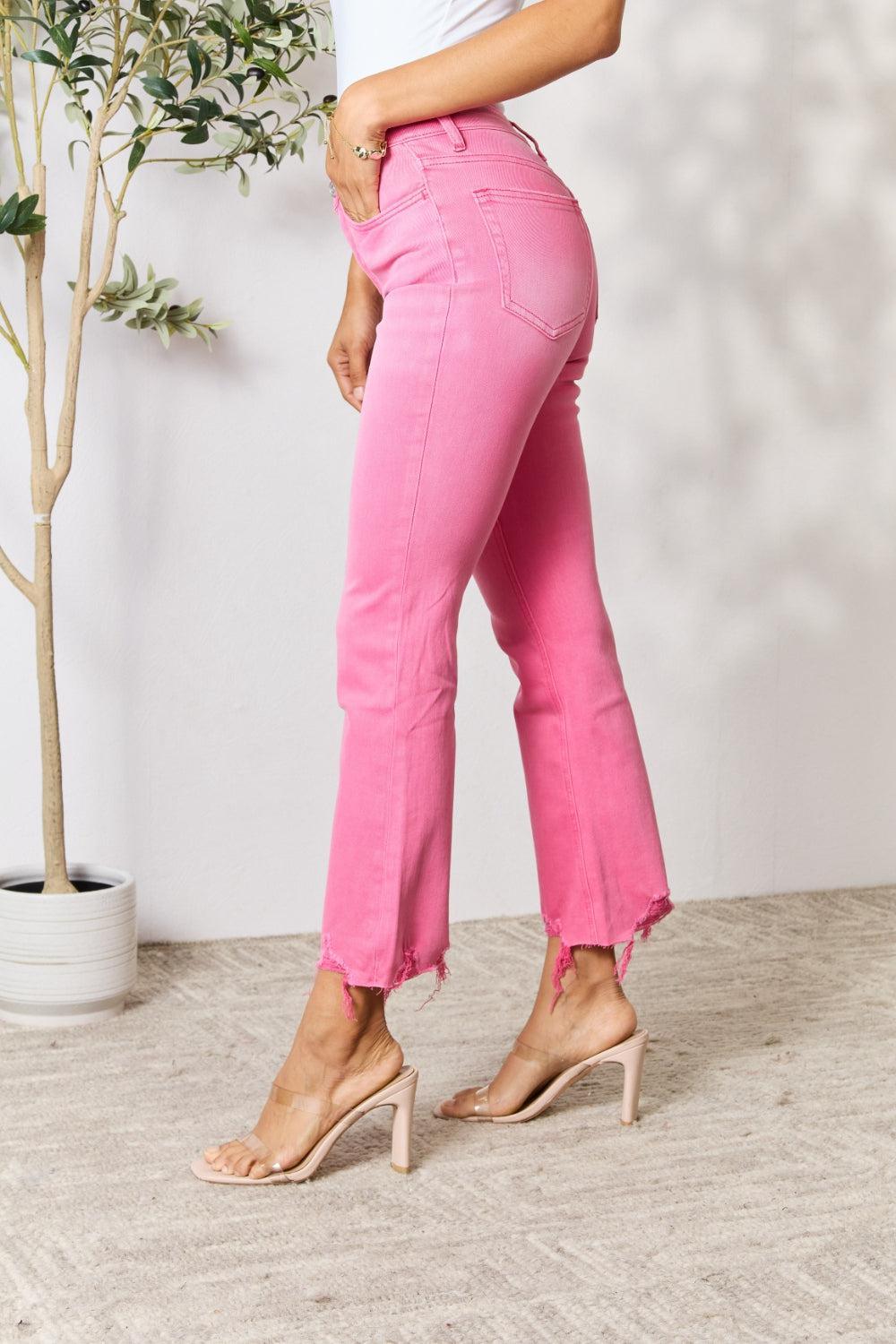 a woman in a white shirt and pink pants