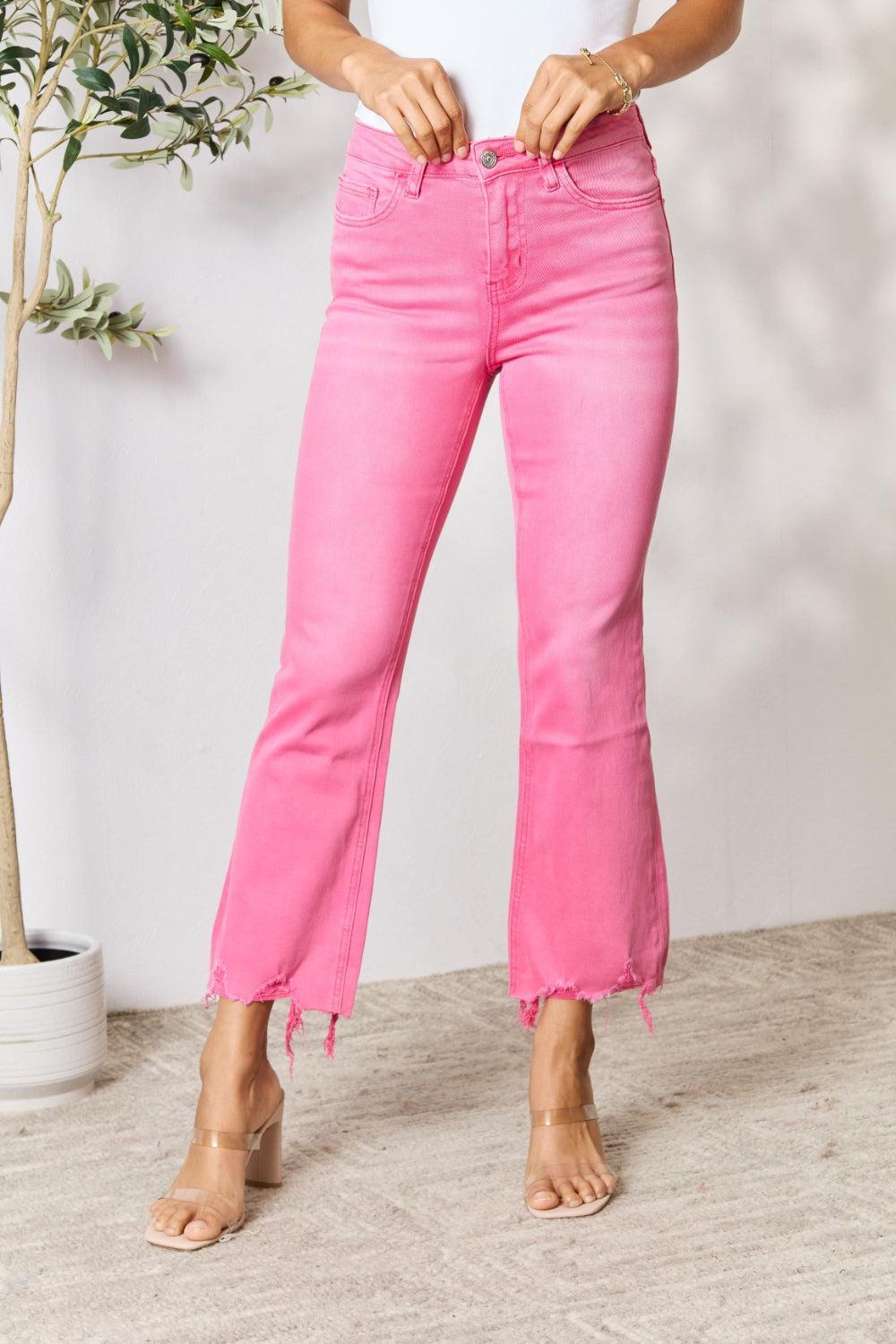 a woman in a white shirt and pink jeans